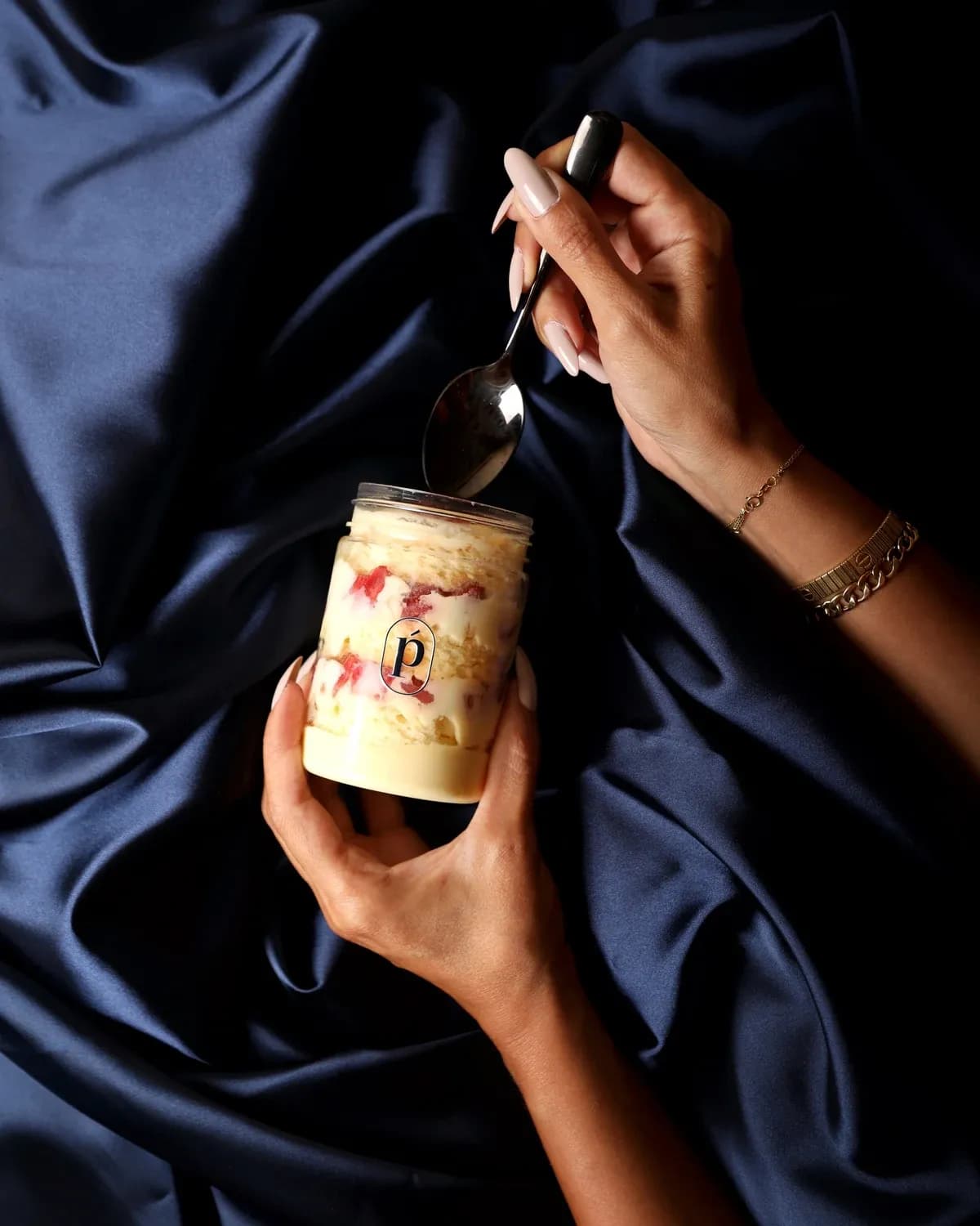 Fraisier, held, with a spoon.