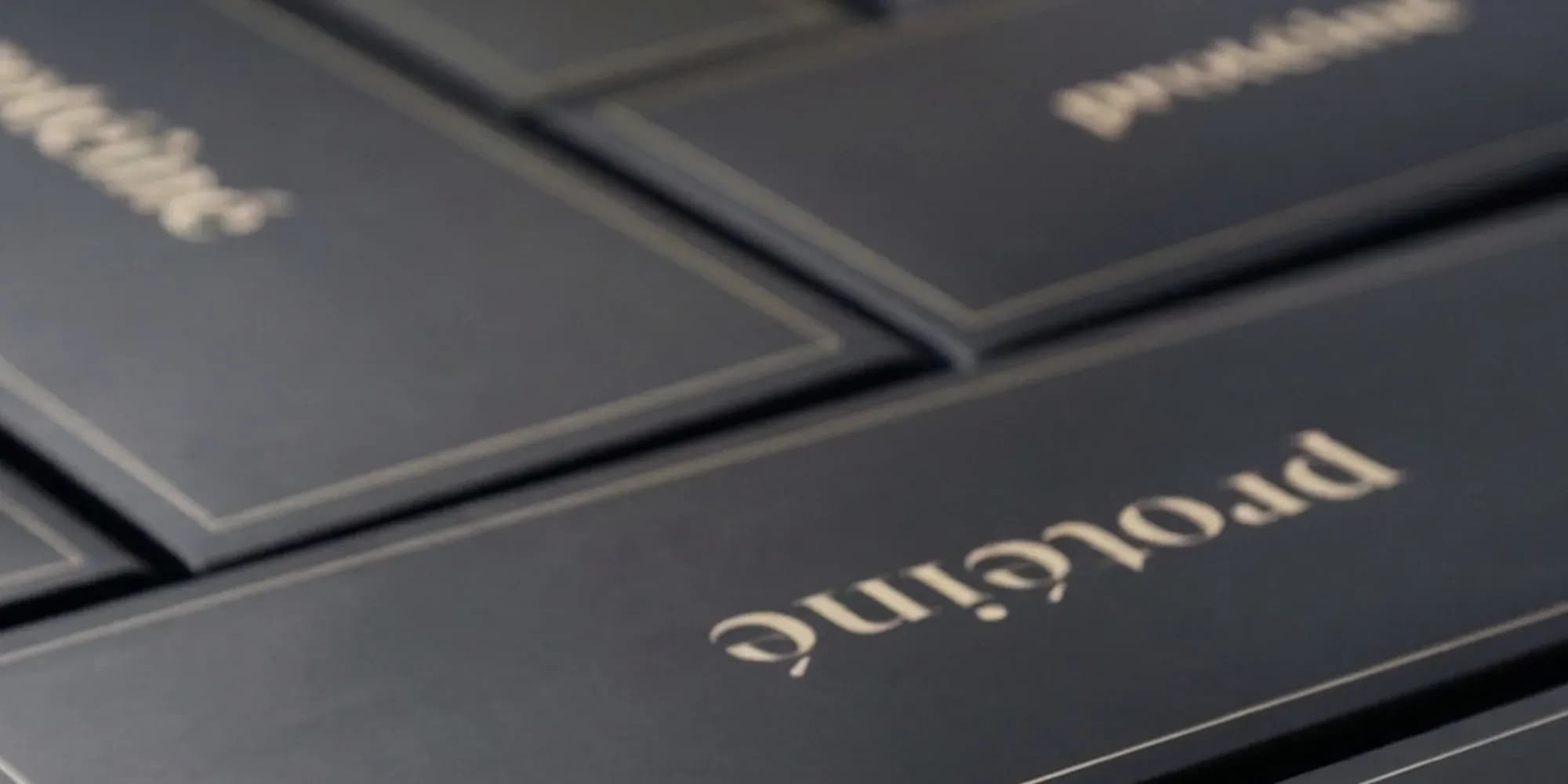 A run of closed boxes, gold wordmark on navy